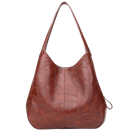 Bolsa shopping oversized marrom da marca Udiyo, sac à main de estilo clássico e amplo, com alça robusta e acabamento elegante.