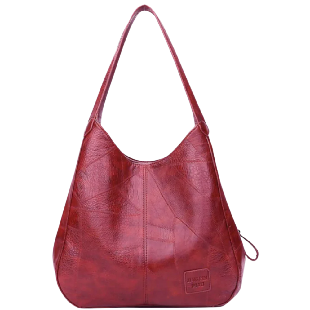 Sac à main oversize clássico da Udiyo, em vermelho, com alça larga e design elegante, adequado para looks sofisticados.