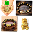 Pulseira de obsidiana preta e detalhes dourados da I-Mart, com acabamento elegante e design de bracelete.