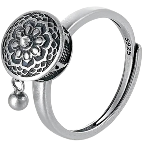 Anel feminino da Freedx com mantra budista rotativo, detalhe de design elegante e símbolo espiritual na superfície.