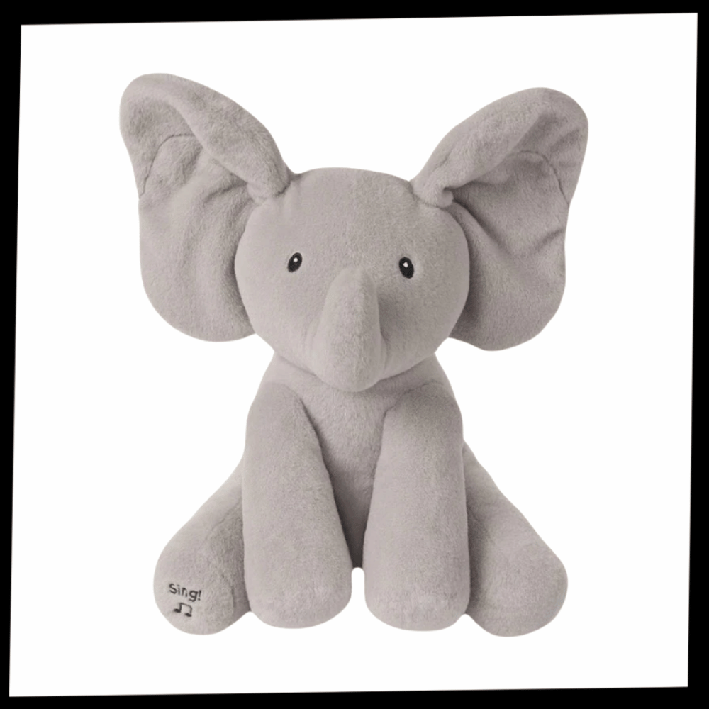 Peluche de elefante interativo da Sun & Roots, brinquedo de pelúcia com recurso de esconder e revelar, ideal para crianças.