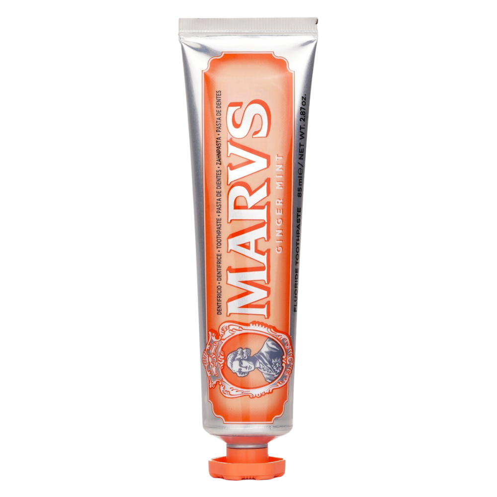 Dentifrice brancchissant à la menthe Marvis, soin buccal, tube mauve avec texture blanche visible, idéal para higiene oral.